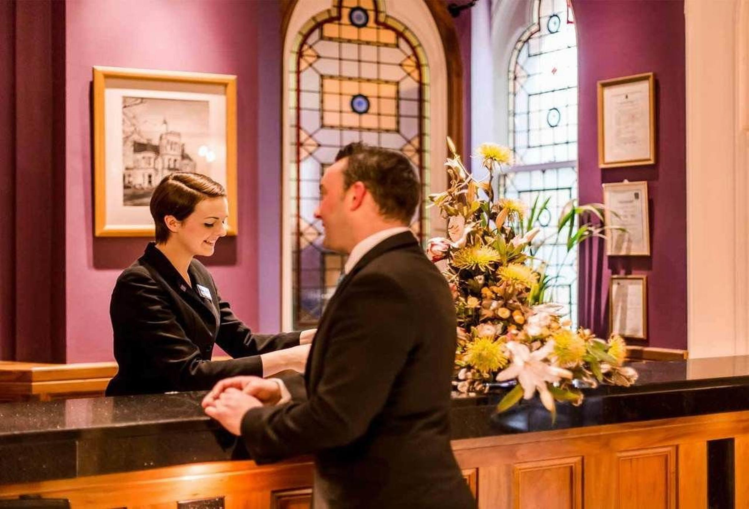 The Culloden Estate And Spa Holywood  Eksteriør billede A hotel receptionist at work